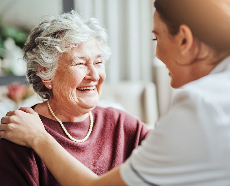 Smiling elderly lady with female nurse